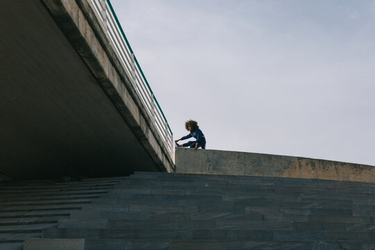 Woman stretching on ledge