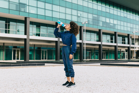  Woman drinking water outdoors