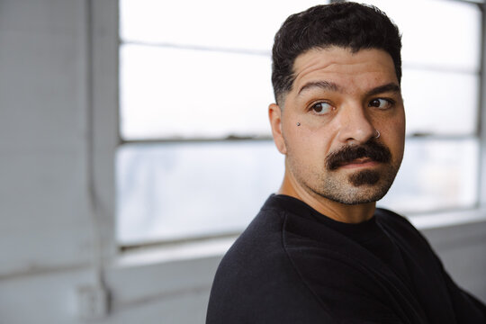 Man Gazing to the Side in Bright Indoor Studio Setting