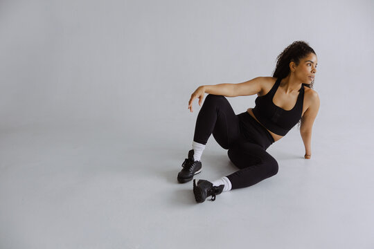 Athlete Stretching in Studio Showcasing Strength and Resilience