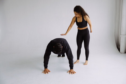Athletic Woman Coaching Push-Up Exercise for Injury Recovery