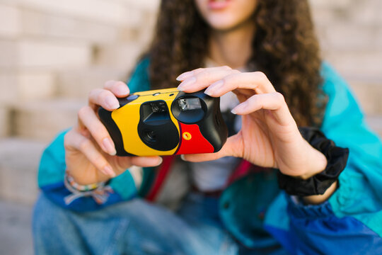 Hands showing disposable camera