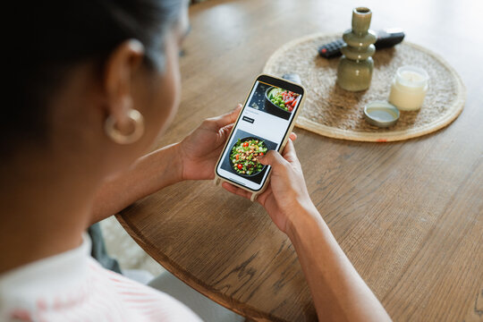 A woman orders takeaway food on her mobile phone