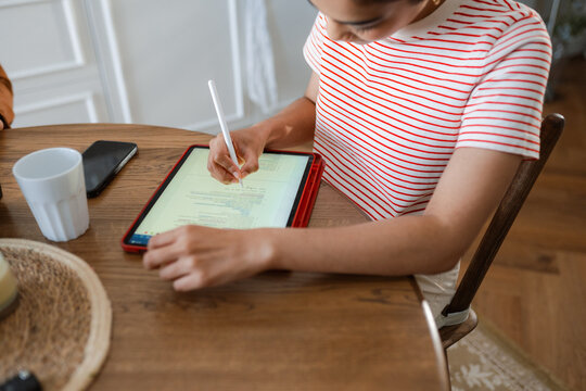 A woman uses a tablet at home