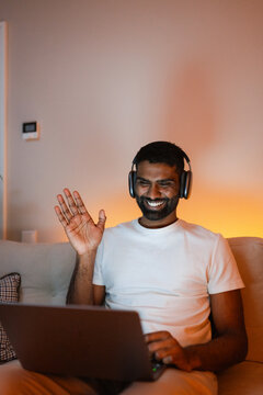 A man uses a laptop at home