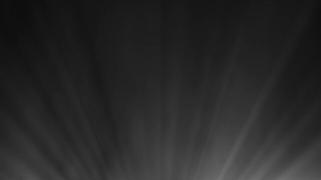 Abstract light rays bursting from the bottom against a dark background, creating a dramatic and atmospheric effect