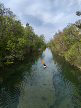 Kayaker in river. X shaped layout 