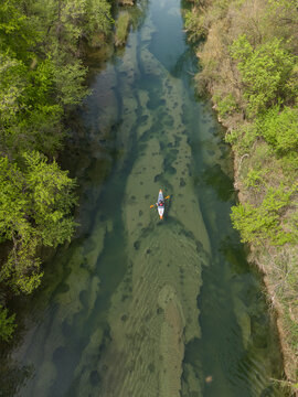 Paddling in a kayak through clear water wetlands