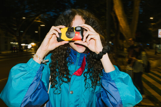 Woman framing shot with camera