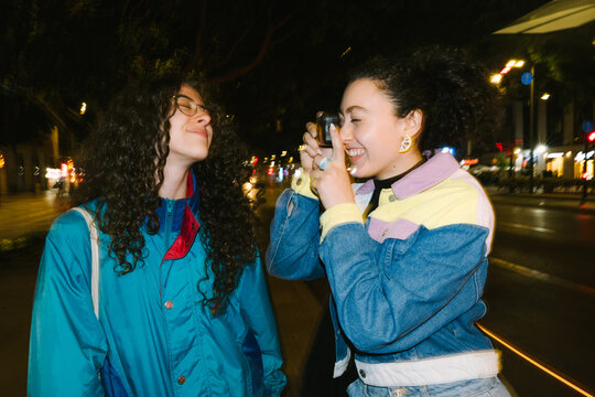 Friends taking photo on street