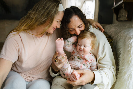 Loving Parents Sharing a Candid Moment With Their Happy Baby