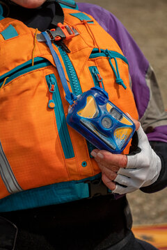 Waterproof disposable camera hanging from kayak life vest