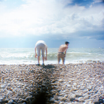 Searching a rocky beach with big waves upfront