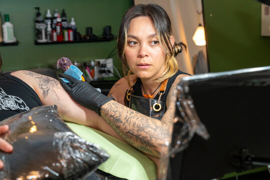 tattoo artist working