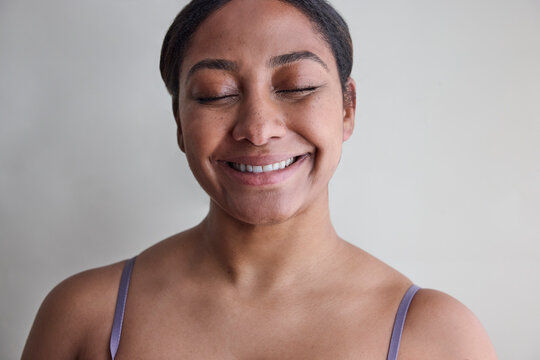 Young woman with no makeup in studio 