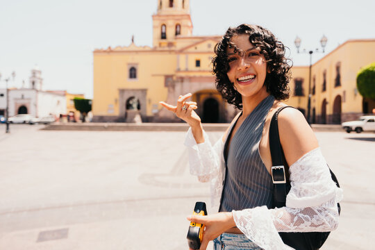 Latinx young woman walking in a Mexican town.