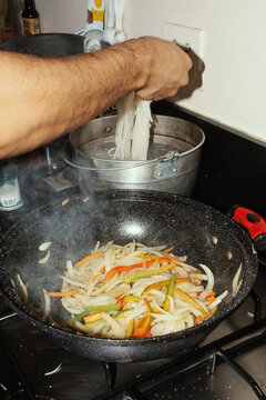 Making pad thai with noodles and vegetables 