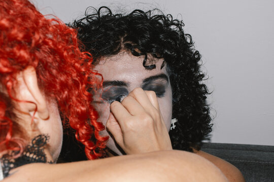 Young man getting gothic makeup 
