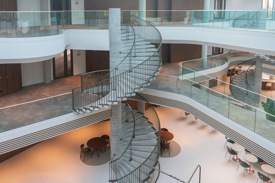 Spiral Staircase In Modern Office Atrium.