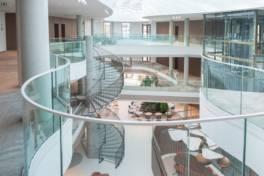 Open Atrium With Glass Railings And Greenery