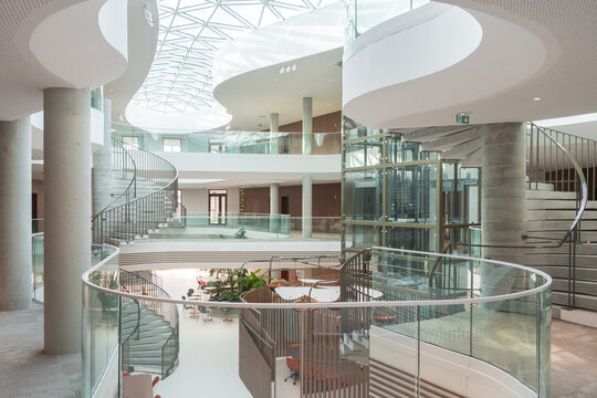 Modern Office Atrium With Spiral Staircases And Skylight