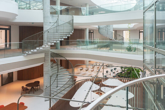 Multi-Level Office Atrium With Curved Staircases


