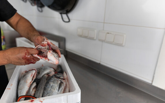 a cook preparing a sea bream