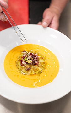 a plate of common salmorejo, Serrano ham, and vegetables
