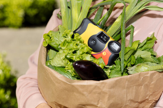 disposable film camera in a bag with vegetables