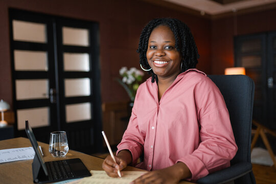 A woman studies documents sitting at her desk