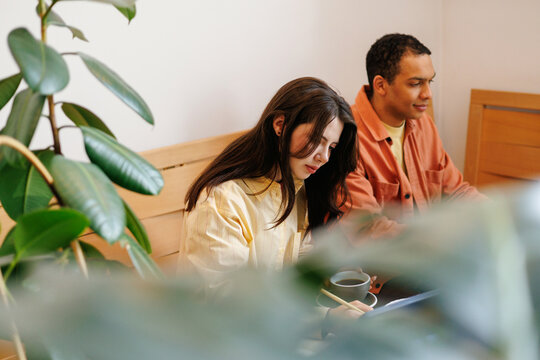 Creative Collaboration Two People Working Together in Cozy Caf&eacute;