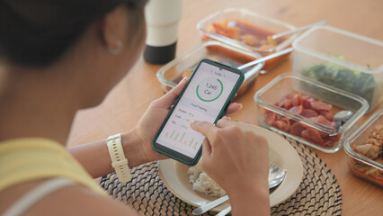 Plakat Young adult black asia people active gen z using AI phone record data daily meal tracker clean food diet app control. Asian Smart living care happy life goal routine plan lunch time home dining table.
