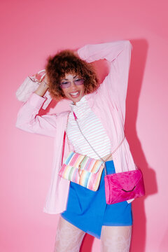 Fashion model wearing multiple bags and pink clothes
