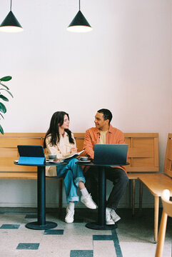 Two Friends Collaborating at Caf&eacute; Table Film photo 
