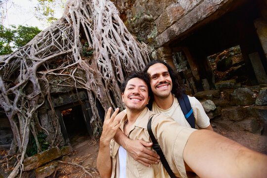 Couple selfie at Ta Prohm temple roots