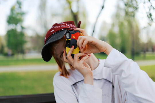Young woman captures moments with a disposable  camera 