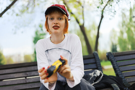 Young woman holding a disposable  camera 