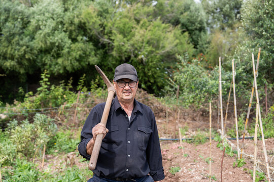 Farmer holding pickaxe on shoulder