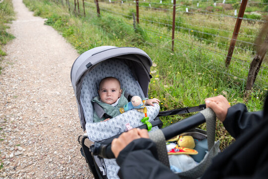 Parent pushing baby stroller