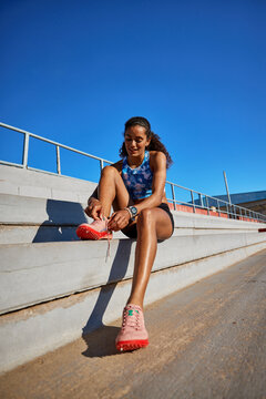 Runner prepares for training on a sunny track