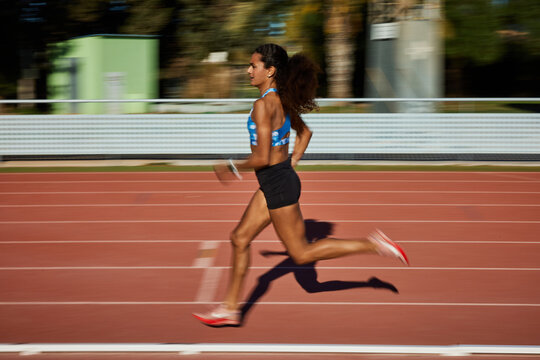 Runner sprinting on an athletic track during daylight