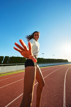 Joyful runner enjoying a sunny day on the track