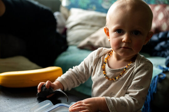 A little blonde baby girl playing