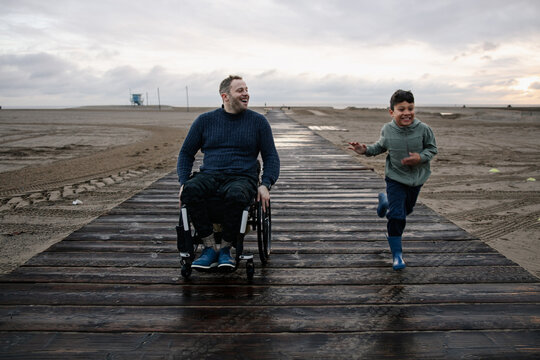Father and Son Enjoying Time Together on a Beach Boardwalk