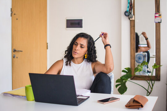Woman looking at laptop screen with sad, worry expression