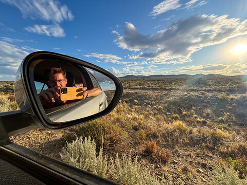POV Reflection of Road Trip Moments in Car Side Mirror