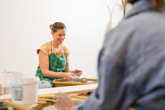 Artist focused on crafting clay in workshop