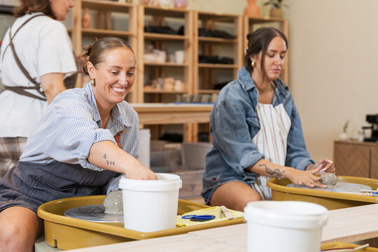 Cheerful pottery class with students enjoying creation
