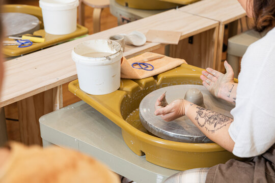 Artisan crafting pottery on a potter's wheel
