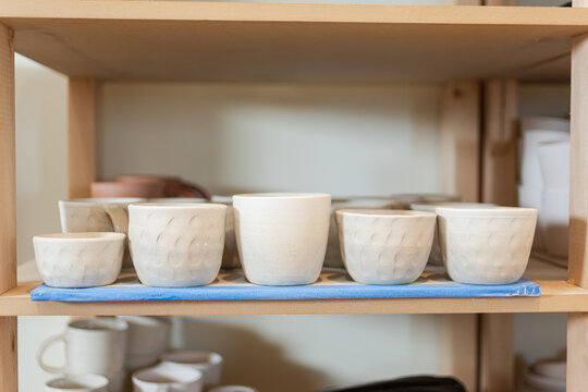 Handcrafted Pottery Cups and Bowls on Display